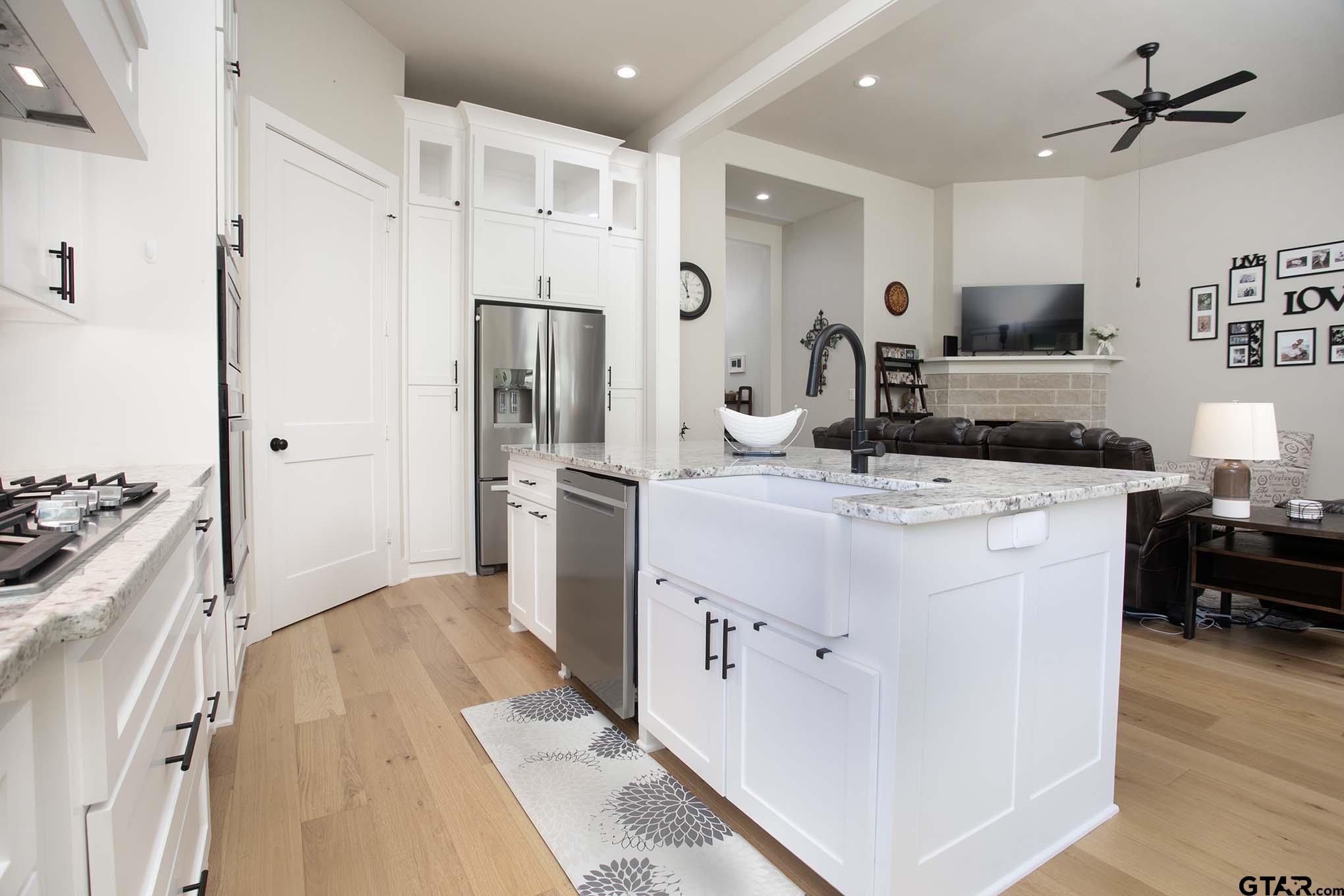 7434 Waterview Square Tyler, TX 75703 - Photo 10 of 33 a kitchen with a refrigerator a sink and a stove top oven