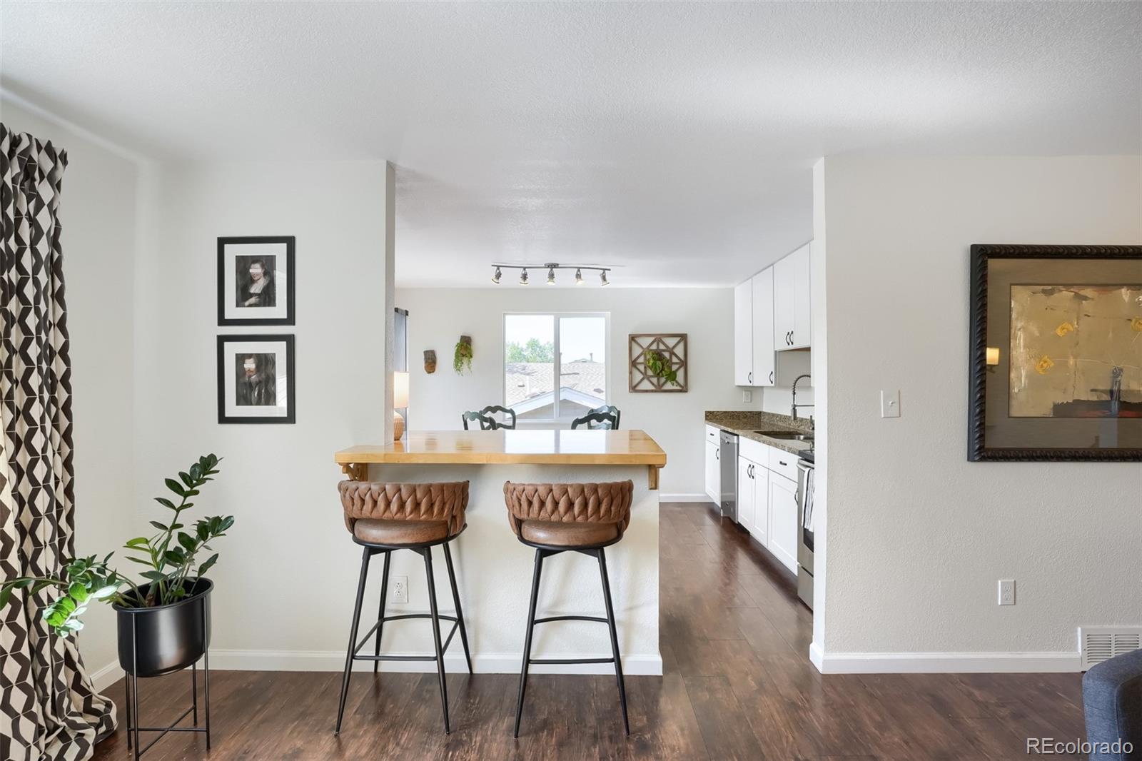 6551 South Albion Way Littleton, CO 80121 - Photo 5 of 37 a view of a dining room with furniture and wooden floor