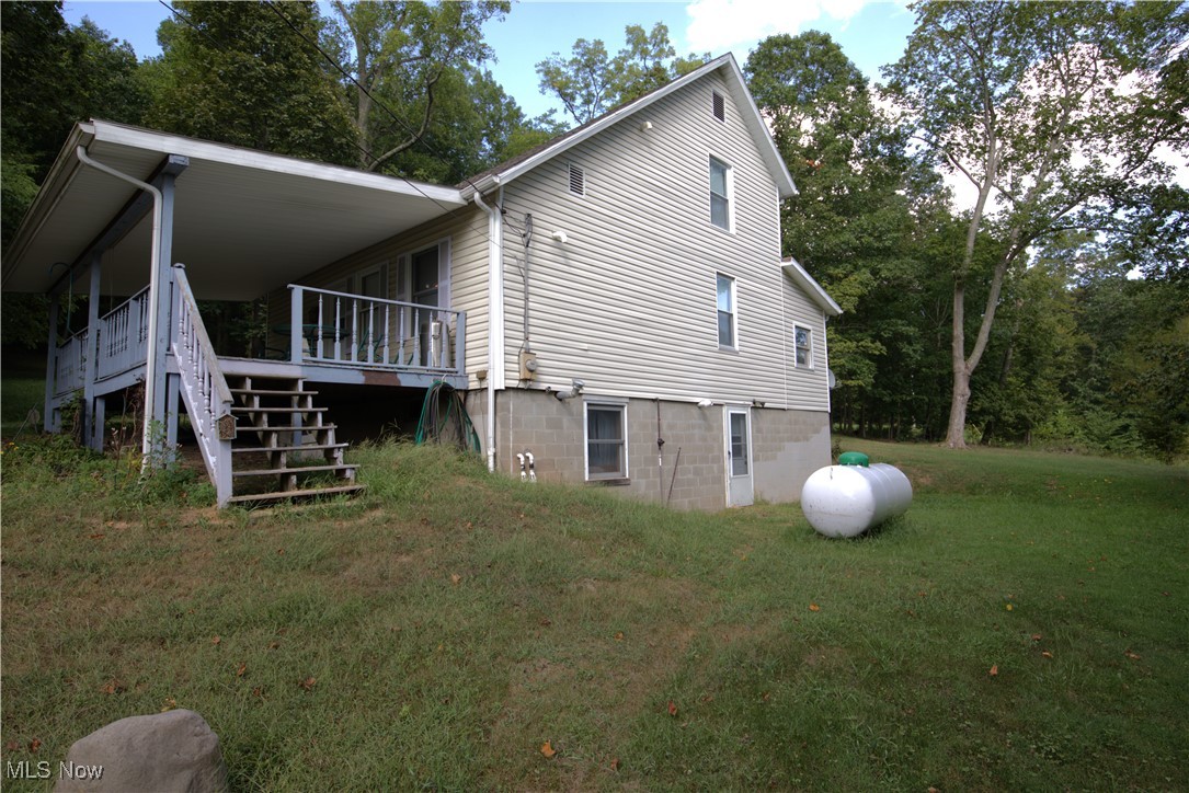 22760 Roy Croy Road Senecaville, OH 43780 - Photo 36 of 46 View of side of property with stairway and a lawn