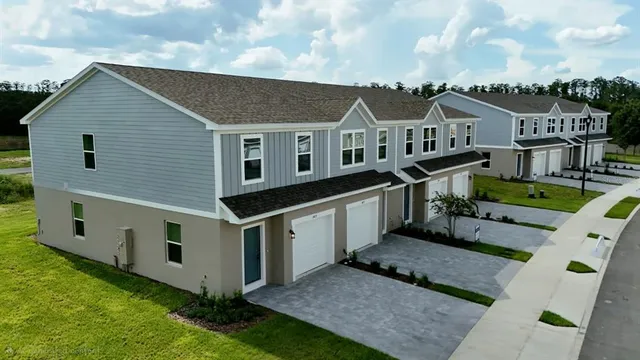 a aerial view of a house with a yard