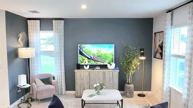 a living room with furniture and a large window