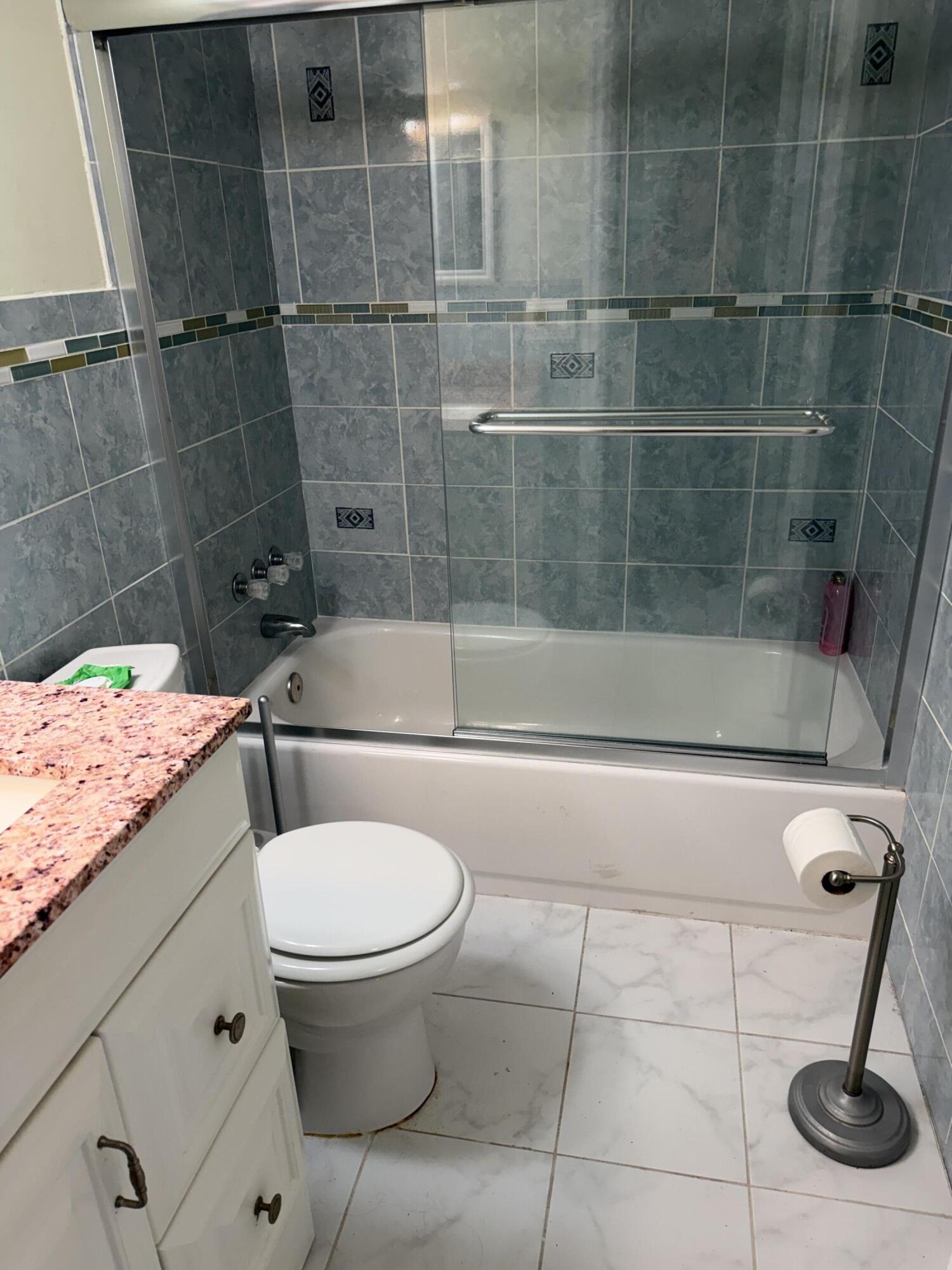 8588 Bella Vista Drive Boca Raton, FL 33433 - Photo 7 of 12 a bathroom with a toilet and a shower