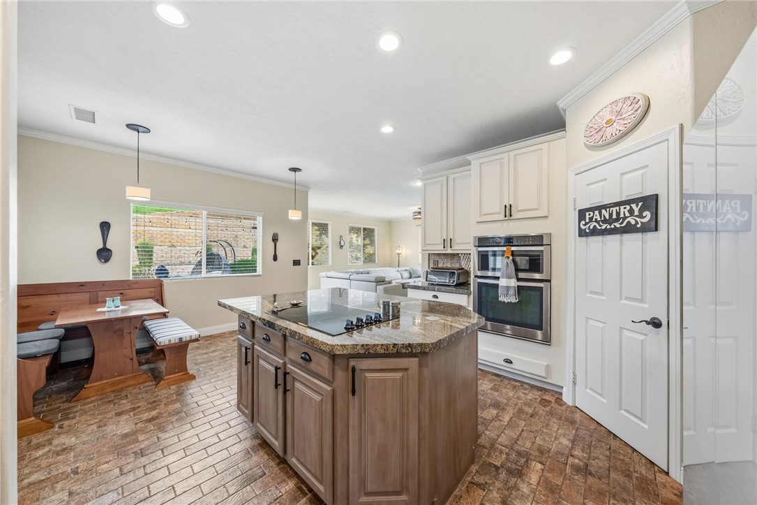 45600 La Cruz Drive Temecula, CA 92590 - Photo 31 of 75 a kitchen with stainless steel appliances granite countertop a sink a stove and a refrigerator