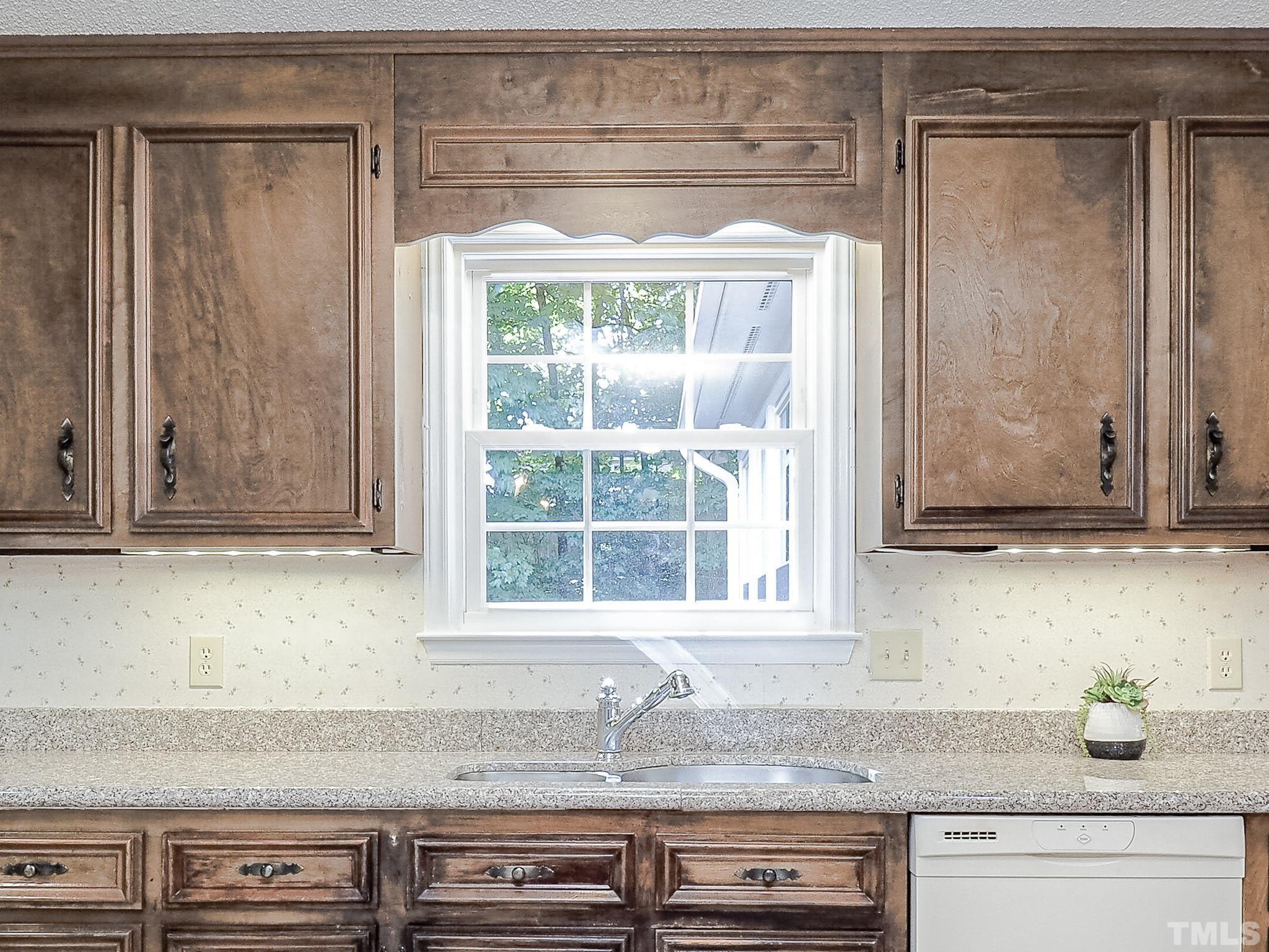 2624 Catalina Drive Raleigh, NC 27607 - Photo 13 of 35 a kitchen with granite countertop cabinets and window