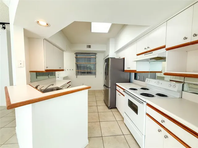 a kitchen that has a sink and a stove top oven