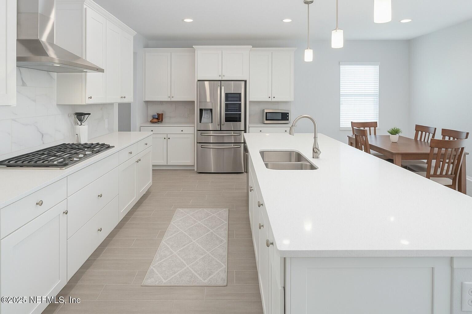 54 Wiltshire Drive St. Augustine, FL 32092 - Photo 2 of 23 a kitchen with a sink a stove a refrigerator and white cabinets
