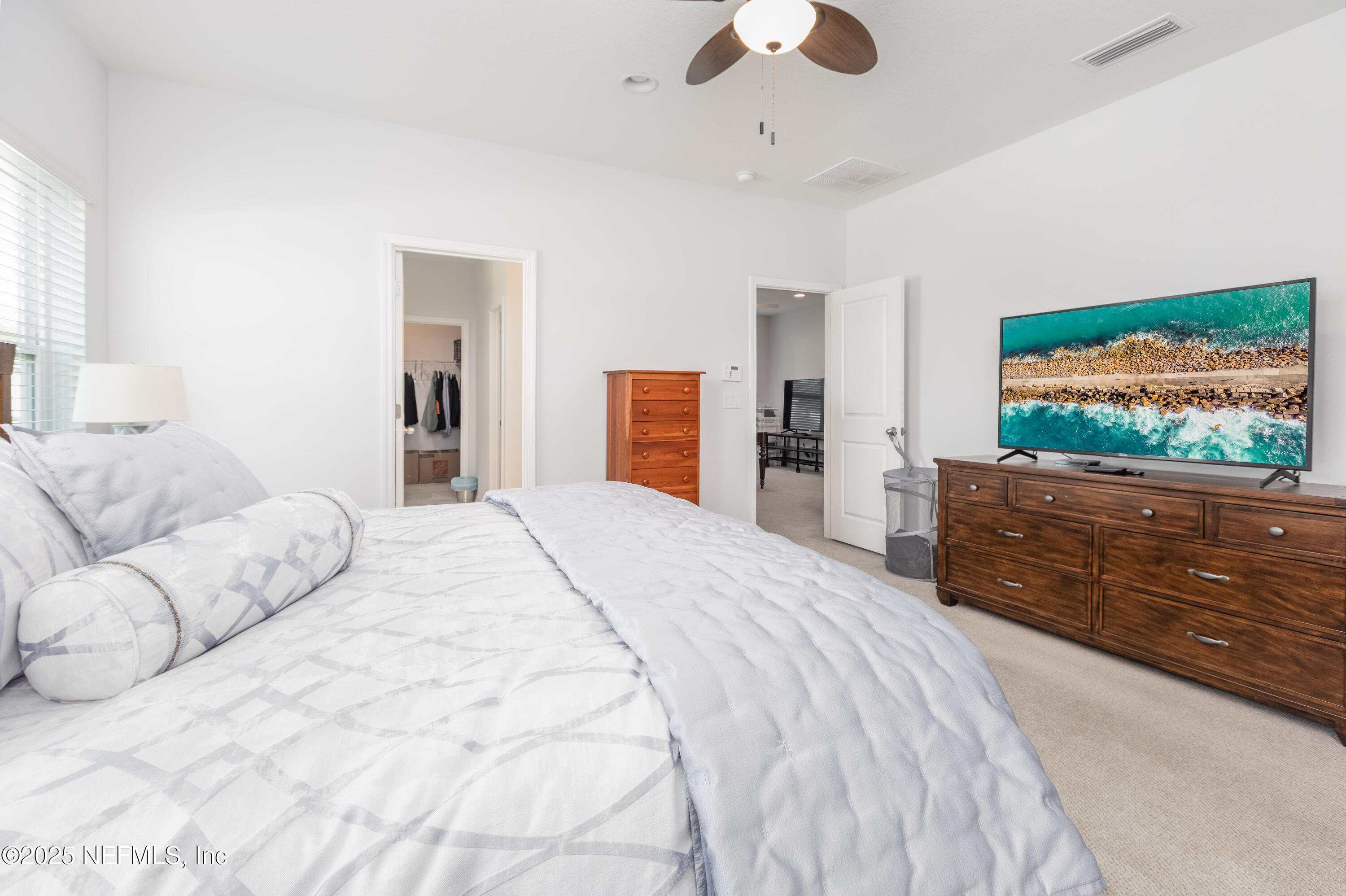 54 Wiltshire Drive St. Augustine, FL 32092 - Photo 6 of 23 a bedroom with a large bed and a flat screen tv