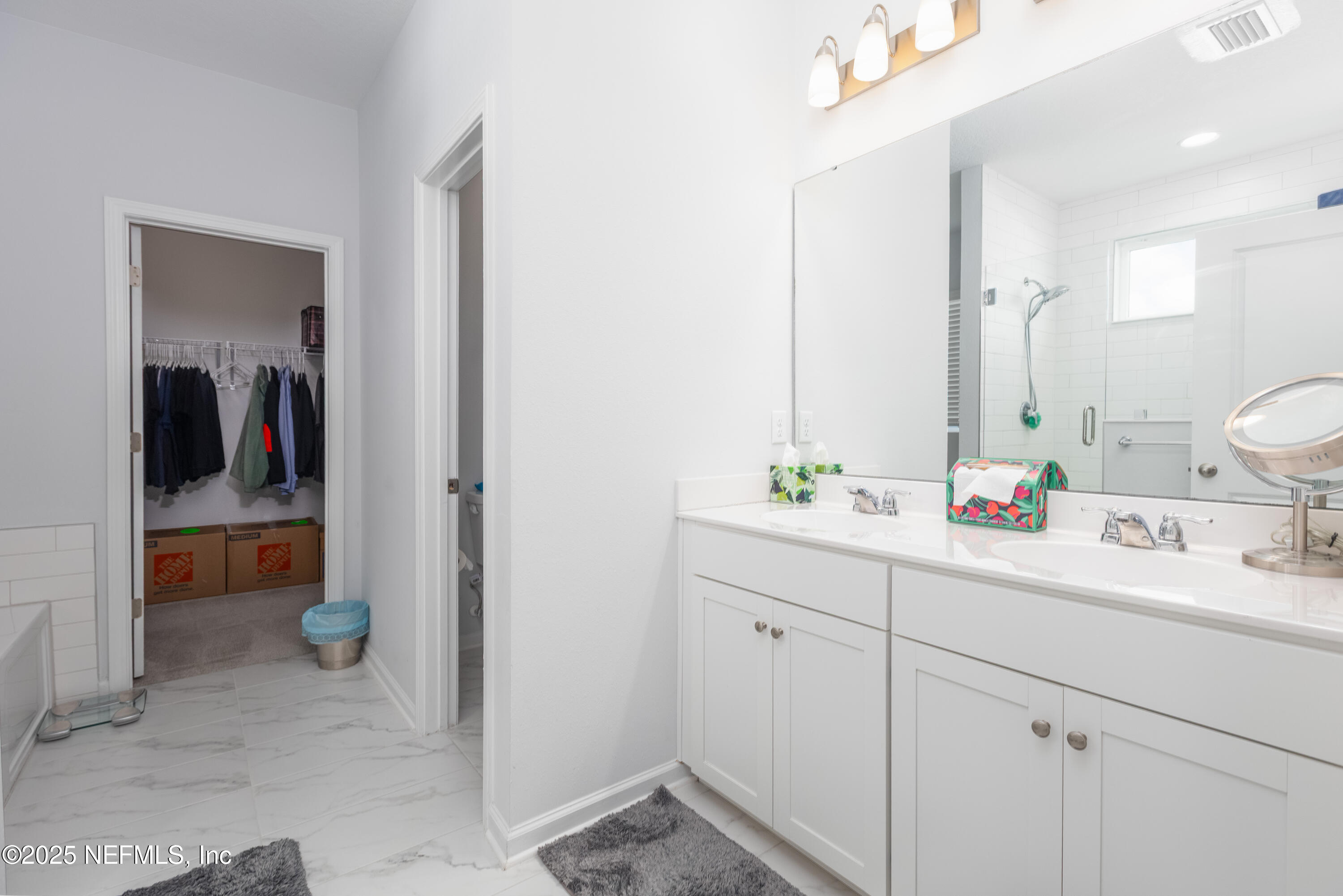 54 Wiltshire Drive St. Augustine, FL 32092 - Photo 7 of 23 a bathroom with a double vanity sink and a mirror