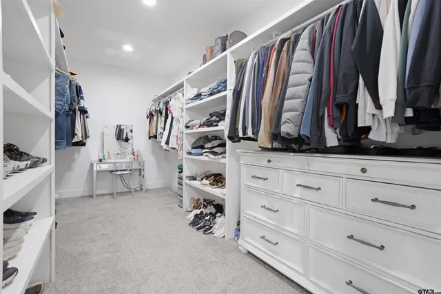 a bedroom with a bed a flat screen tv and dresser