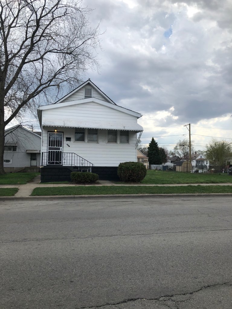 117 Pulaski Road Calumet City, IL 60409 - Photo 1 of 9 a front view of a house with a garden and plants