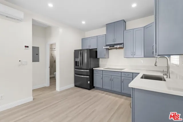 a kitchen with stainless steel appliances granite countertop a refrigerator sink and cabinets