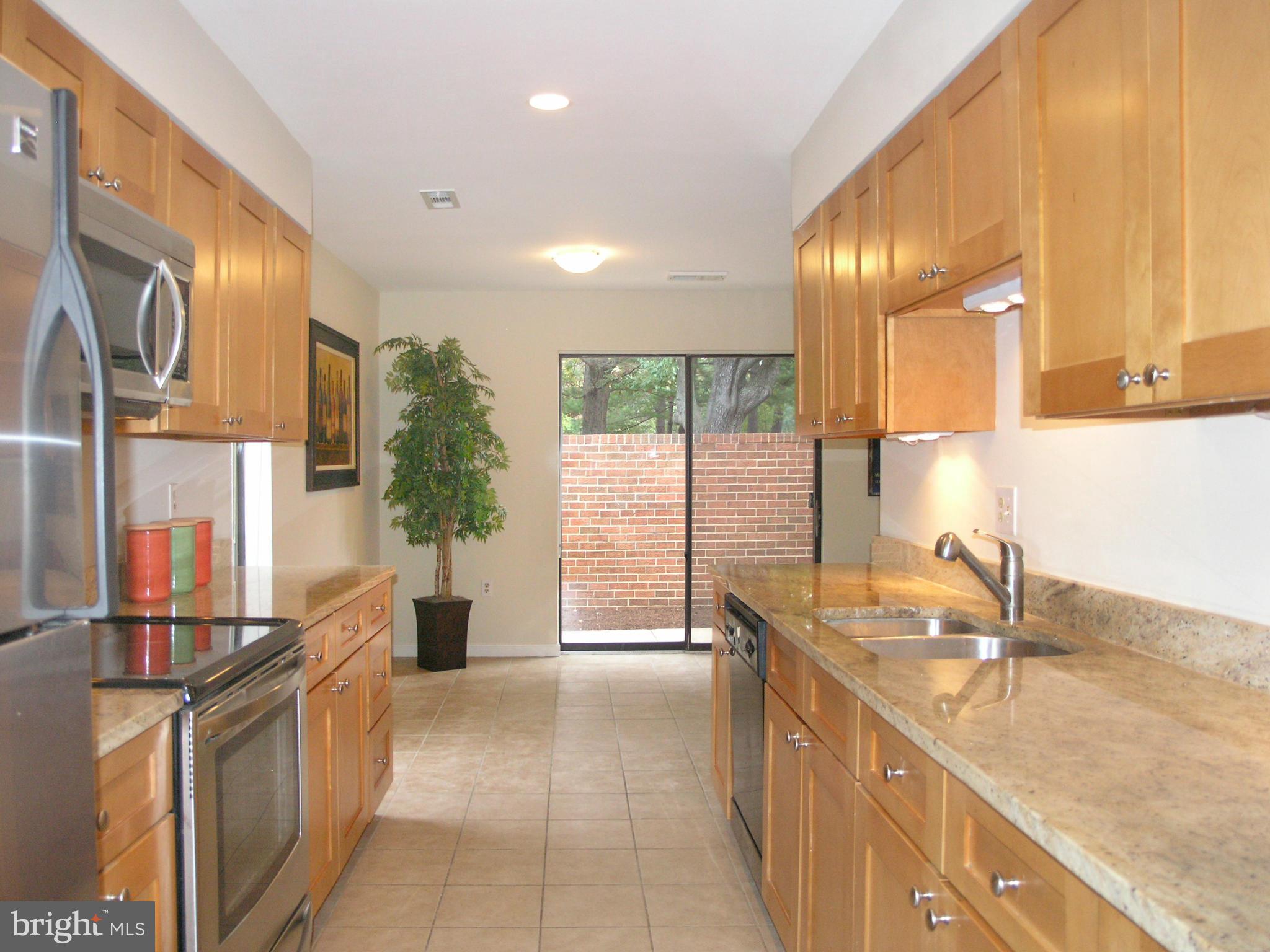 11623 Hunters Green Court Reston, VA 20191 - Photo 14 of 30 a kitchen with stainless steel appliances granite countertop a sink and a counter