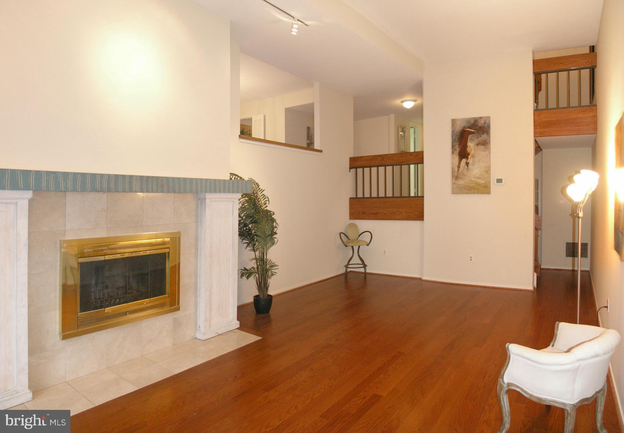 11623 Hunters Green Court Reston, VA 20191 - Photo 22 of 30 a living room with furniture and a fireplace