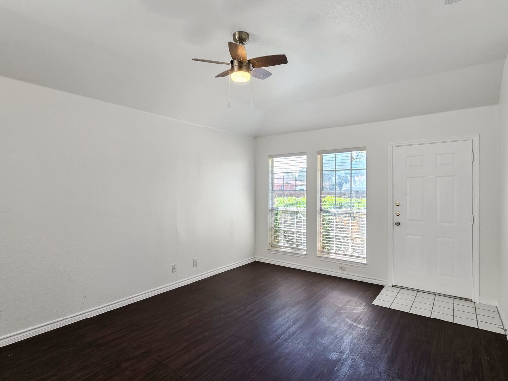 300 Tamara Drive, Unit B Georgetown, TX 78628 - Photo 4 of 16 an empty room with wooden floor fan and windows