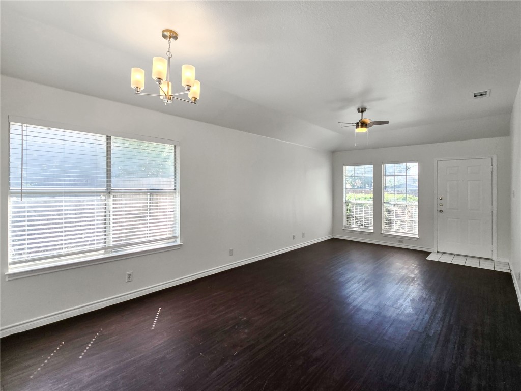 300 Tamara Drive, Unit B Georgetown, TX 78628 - Photo 7 of 16 a view of an empty room with wooden floor and a window