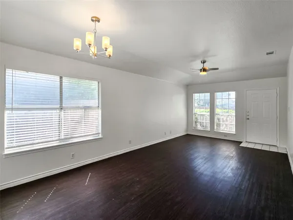 a kitchen with a sink a refrigerator a stove top oven a counter space and wooden floor