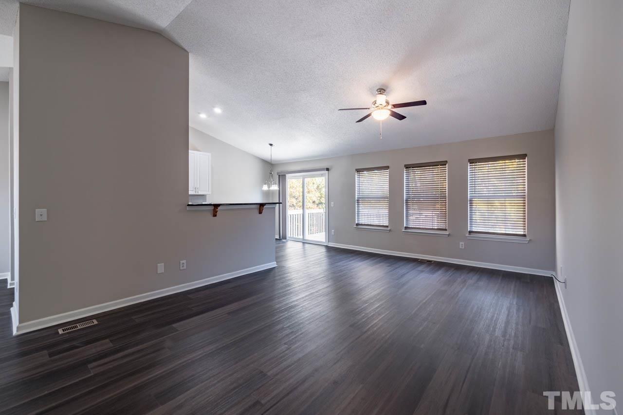 5016 Marathon Lane Raleigh, NC 27616 - Photo 14 of 27 a view of an empty room with a window and wooden floor