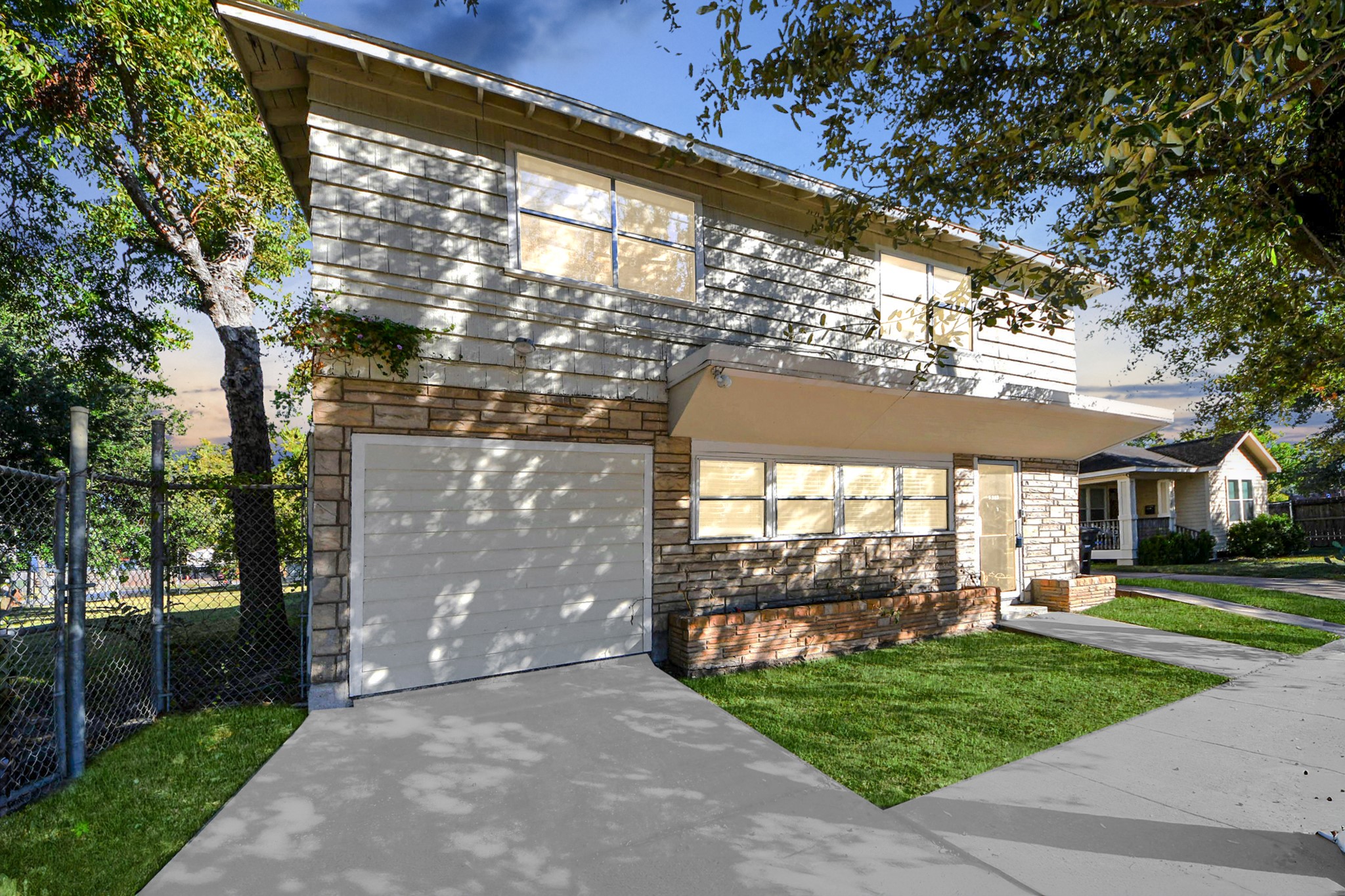 a front view of a building with a garden