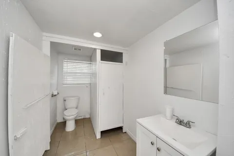 a bathroom with a sink toilet and vanity