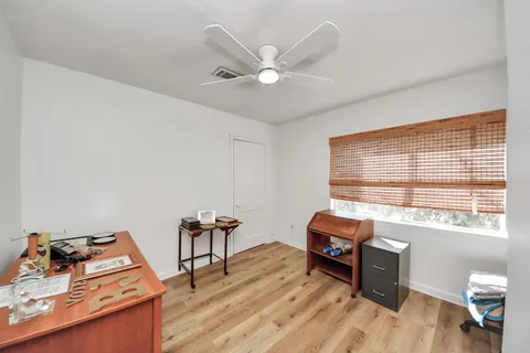 a work room with furniture and wooden floor