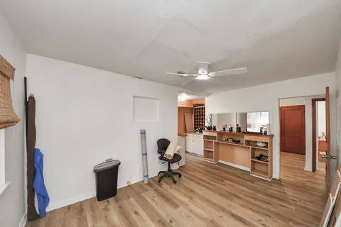 a living room with stainless steel appliances furniture and a kitchen view