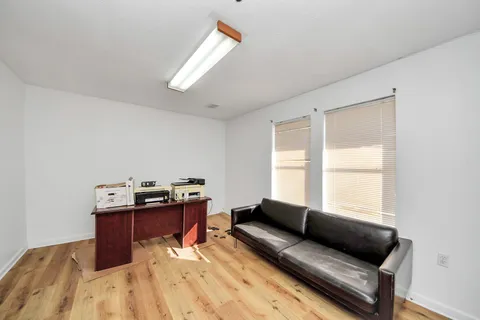 a living room with furniture and dresser