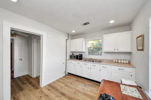 a kitchen with a sink stove and cabinets