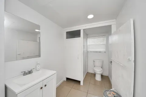 a bathroom with a sink toilet and shower