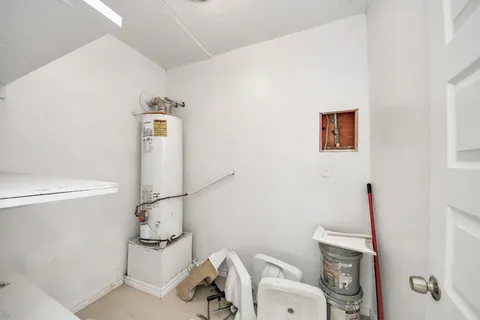 a white toilet sitting next to a bathroom sink and a mirror