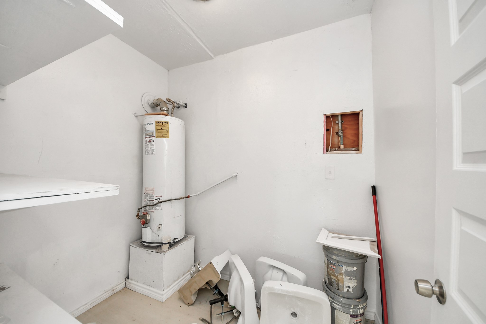 5303 Lyons Avenue, Unit 4 Houston, TX 77020 - Photo 33 of 40 a white toilet sitting next to a bathroom sink and a mirror