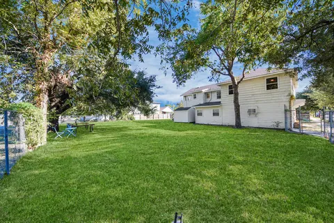 a view of a backyard with large trees