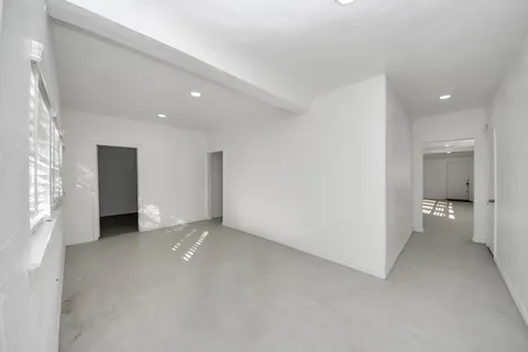 an empty room with a bathroom and a bathroom