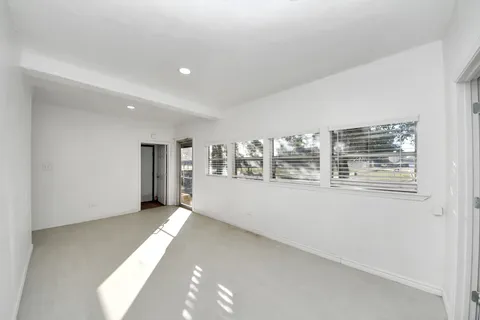 a view of an empty room with chandelier