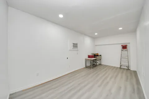 an empty room with a bench and a window