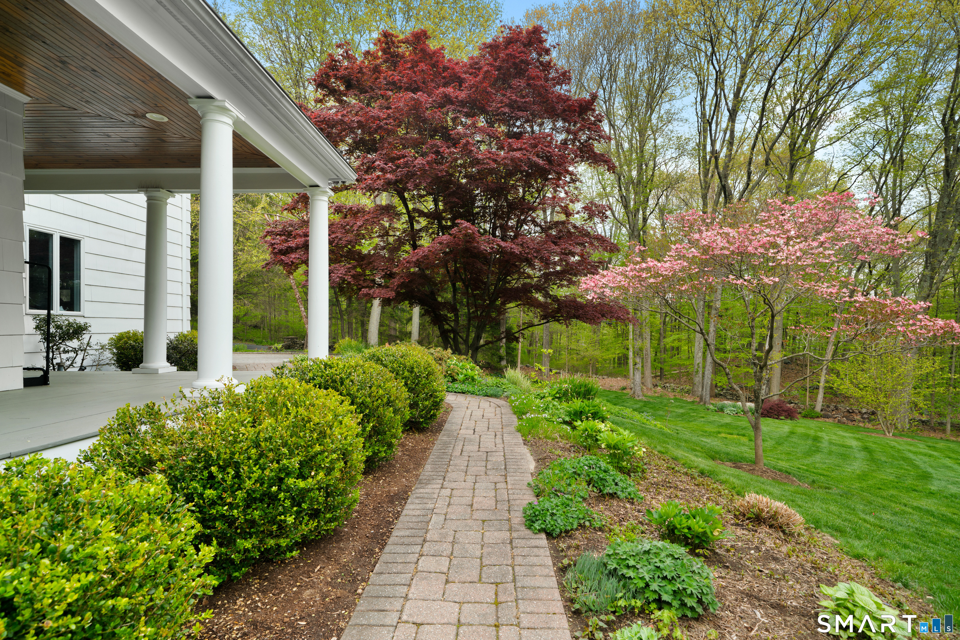 23 Norton Road Easton, CT 06612 - Photo 11 of 40 The pathway to the home is lined with mature plantings, leading to a covered front porch with a private, inviting feel.