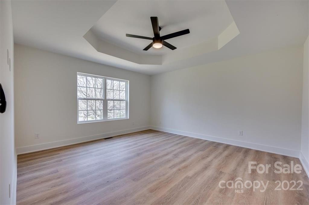 1009 Rainbow Circle Catawba, SC 29704 - Photo 13 of 21 an empty room with wooden floor ceiling fan and windows