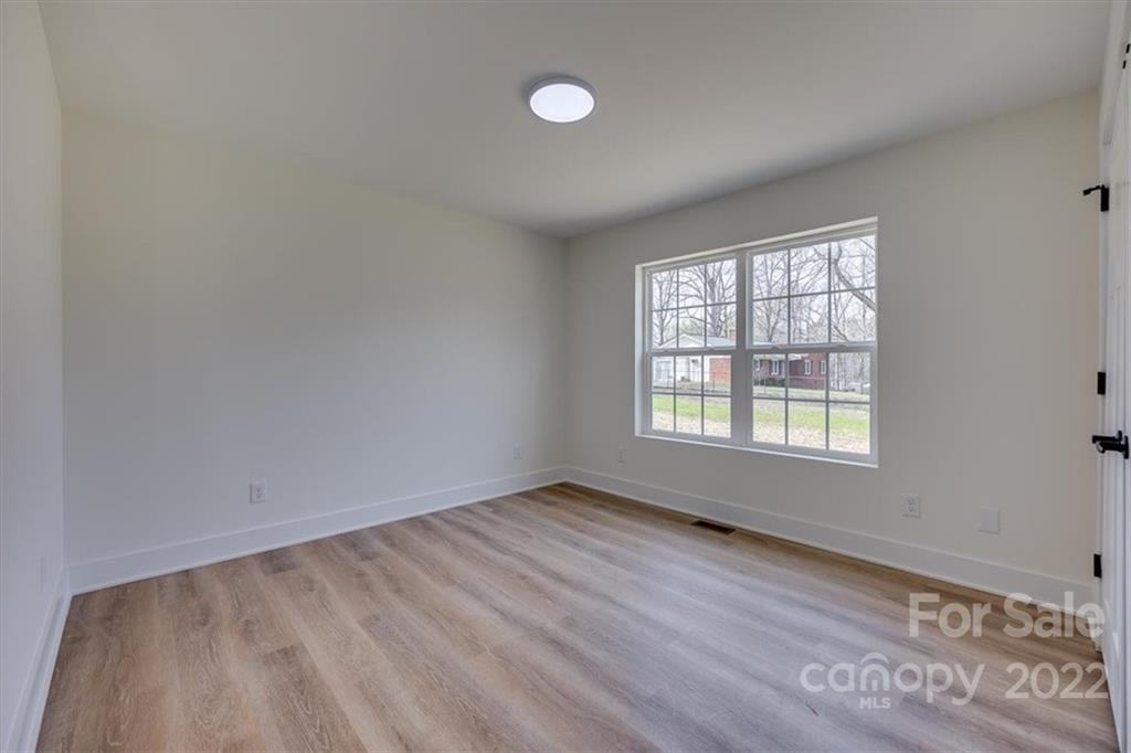 1009 Rainbow Circle Catawba, SC 29704 - Photo 5 of 21 an empty room with wooden floor and windows