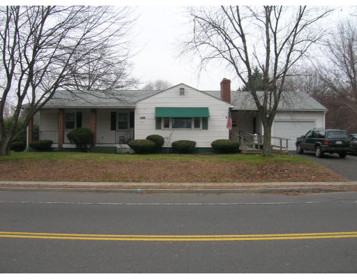 676 Granby Road Chicopee, MA 01013 - Photo 1 of 13 a view of a white house with a large tree