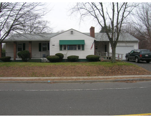 676 Granby Road Chicopee, MA 01013 - Photo 13 of 13 a front view of a house with a garden and parking
