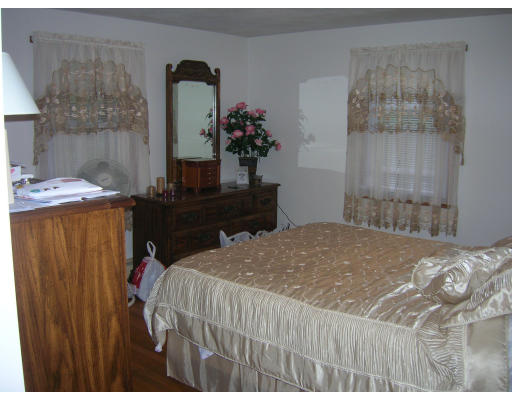 676 Granby Road Chicopee, MA 01013 - Photo 4 of 13 a bedroom with a bed and dresser with mirror