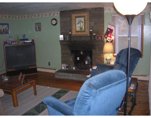 676 Granby Road Chicopee, MA 01013 - Photo 8 of 13 a living room with furniture and a fireplace