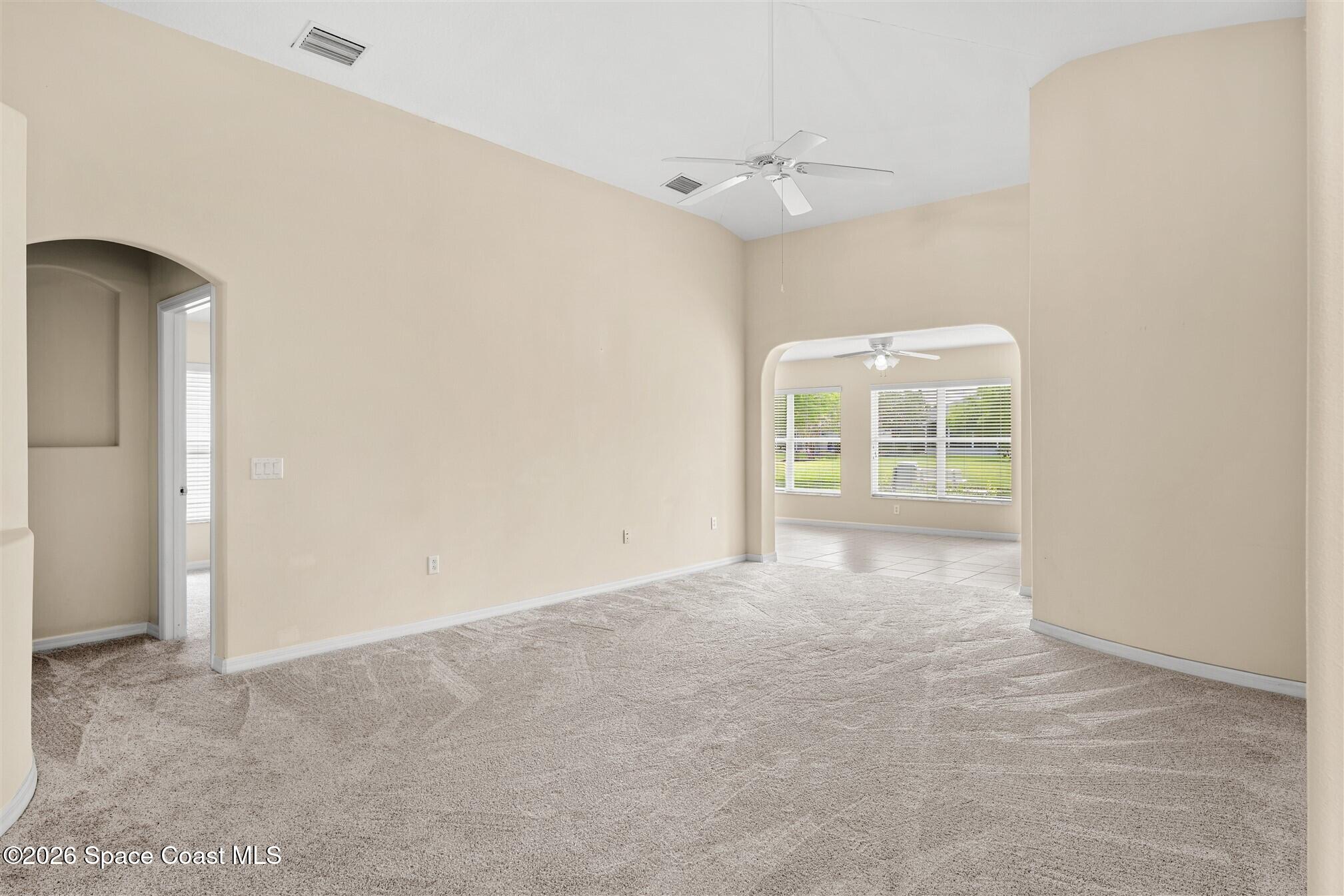 6904 Renshaw Drive Melbourne, FL 32940 - Photo 16 of 46 an empty room with windows