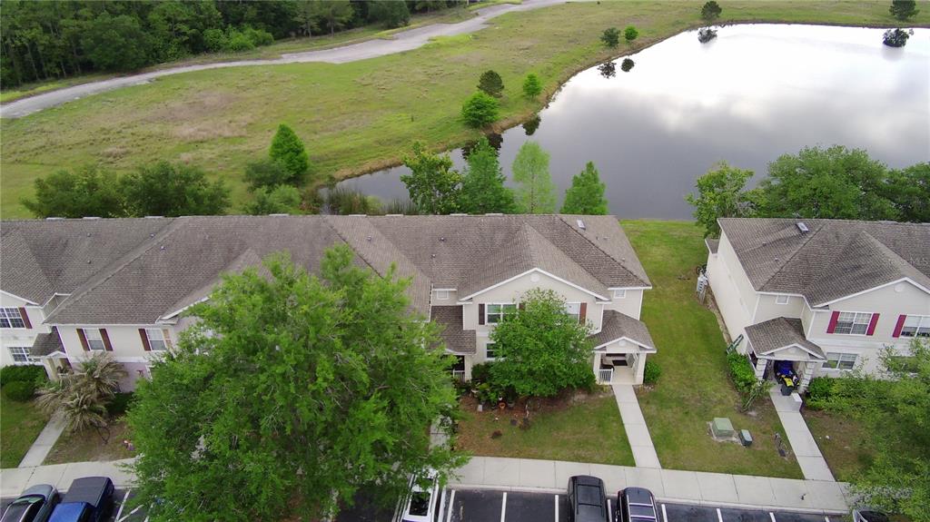 2543 Old Kent Circle Kissimmee, FL 34758 - Photo 1 of 41 an aerial view of a house with a garden and lake view