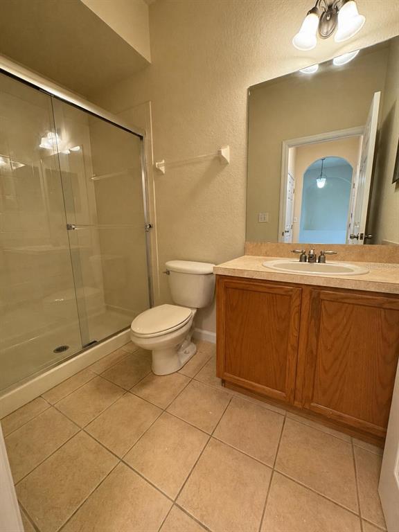 2543 Old Kent Circle Kissimmee, FL 34758 - Photo 16 of 41 a bathroom with a sink a toilet and shower