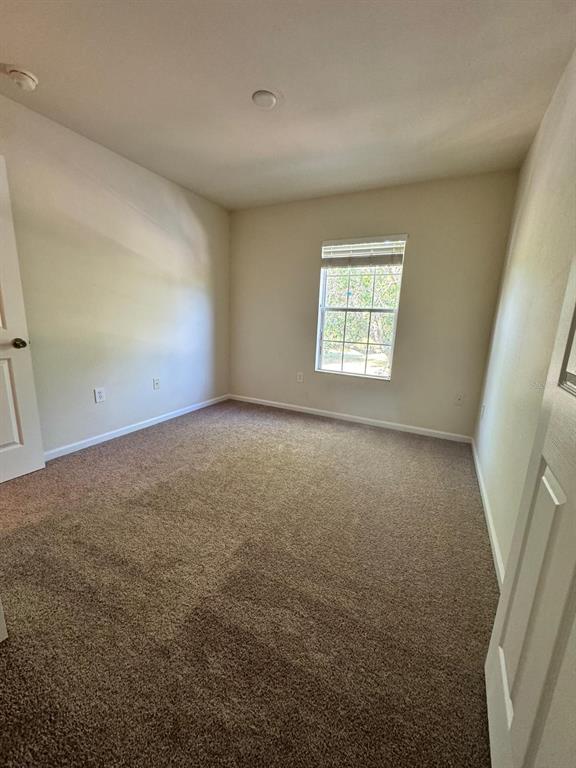 2543 Old Kent Circle Kissimmee, FL 34758 - Photo 18 of 41 an empty room with windows