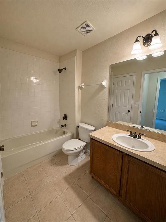 2543 Old Kent Circle Kissimmee, FL 34758 - Photo 19 of 41 a bathroom with a double vanity sink toilet and shower