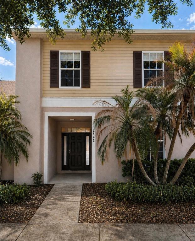 2543 Old Kent Circle Kissimmee, FL 34758 - Photo 2 of 41 a front view of a house with a yard and a garage