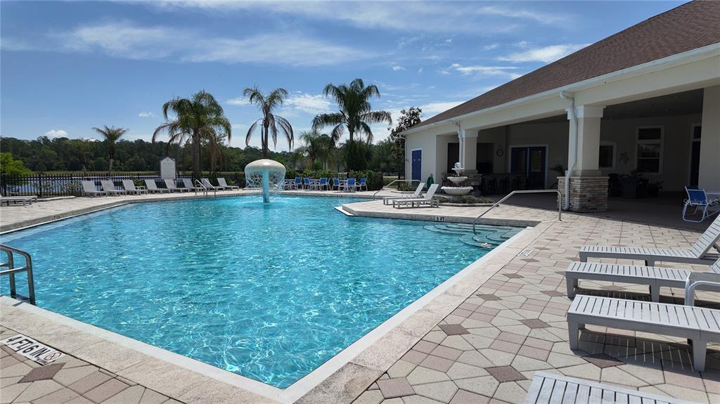 2543 Old Kent Circle Kissimmee, FL 34758 - Photo 32 of 41 a view of a swimming pool and lounge chair