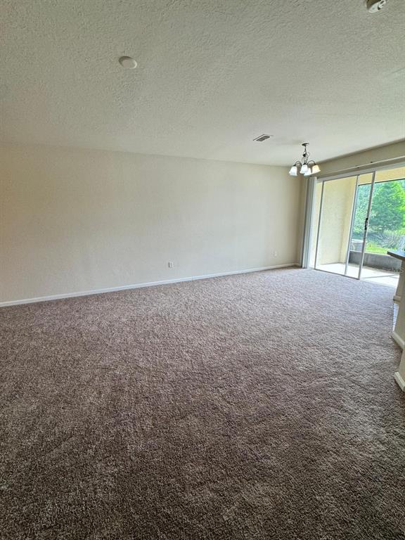 2543 Old Kent Circle Kissimmee, FL 34758 - Photo 6 of 41 an empty room with windows and stairs