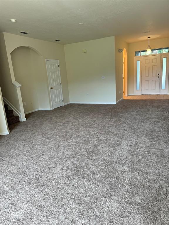 2543 Old Kent Circle Kissimmee, FL 34758 - Photo 8 of 41 an empty room with a fireplace and windows